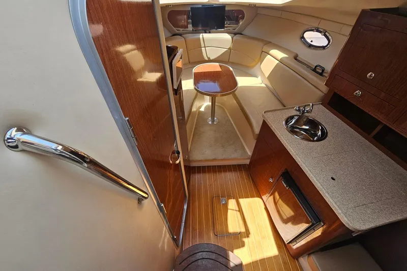 Slide: The Image of Interior of 2009 Regal 2860 Window Express boat with kitchenette and seating area. - 24