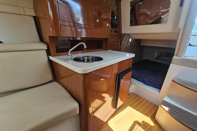 Slide: The Image of 2009 Regal 2860 Window Express interior with kitchenette, sink, and cozy sleeping area. - 26