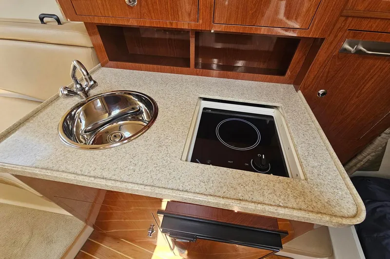 Slide: The Image of 2009 Regal 2860 Window Express boat interior with sink and stove in kitchenette. - 28