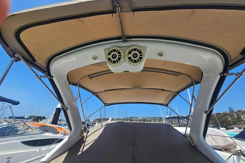 Slide: The Image of 2009 Regal 2860 Window Express boat canopy with speakers, docked in a marina. - 3