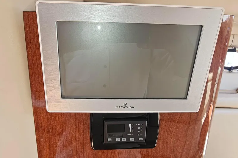 Slide: The Image of Marathon TV and control panel on 2009 Regal 2860 Window Express yacht interior. - 32