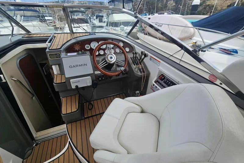 Slide: The Image of 2009 Regal 2860 Window Express boat cockpit with Garmin navigation system and white captain's chair. - 4