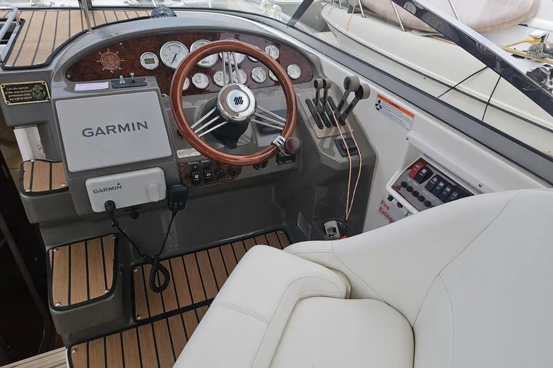 Slide: The Image of 2009 Regal 2860 Window Express boat cockpit with Garmin navigation system and wooden steering wheel. - 5