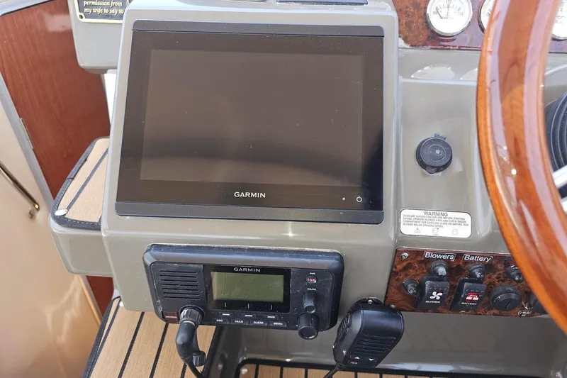 Slide: The Image of 2009 Regal 2860 Window Express dashboard with Garmin navigation system and controls. - 7