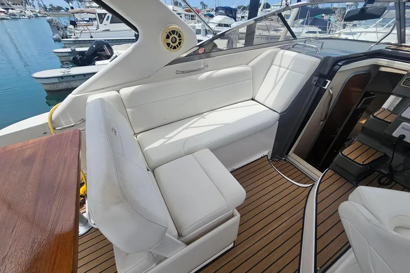 Slide: The Image of 2009 Regal 2860 Window Express boat interior with white seating and wooden flooring. - 9