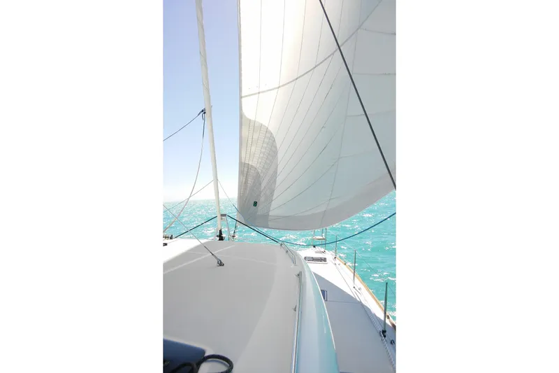 Slide: The Image of Sailing on a 2016 Lagoon 450 F catamaran with white sails and turquoise sea. - 4