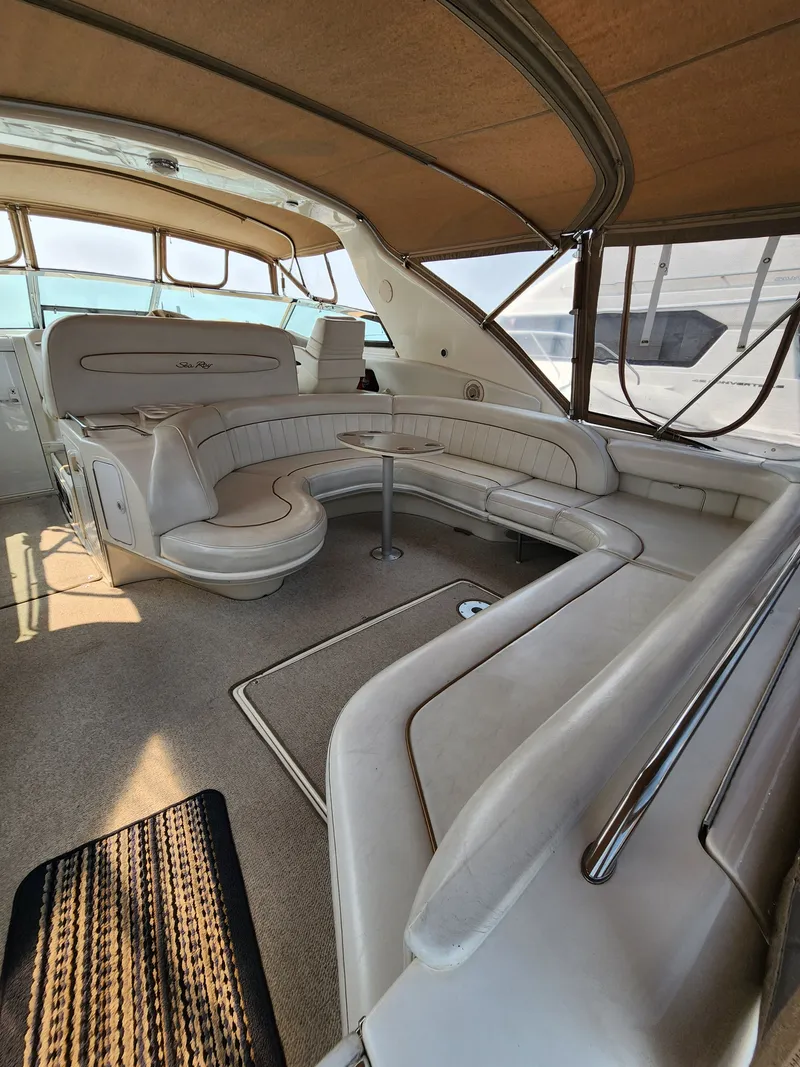 Slide: The Image of Interior of a 1997 Sea Ray 450 Sundancer yacht with beige seating. - 10