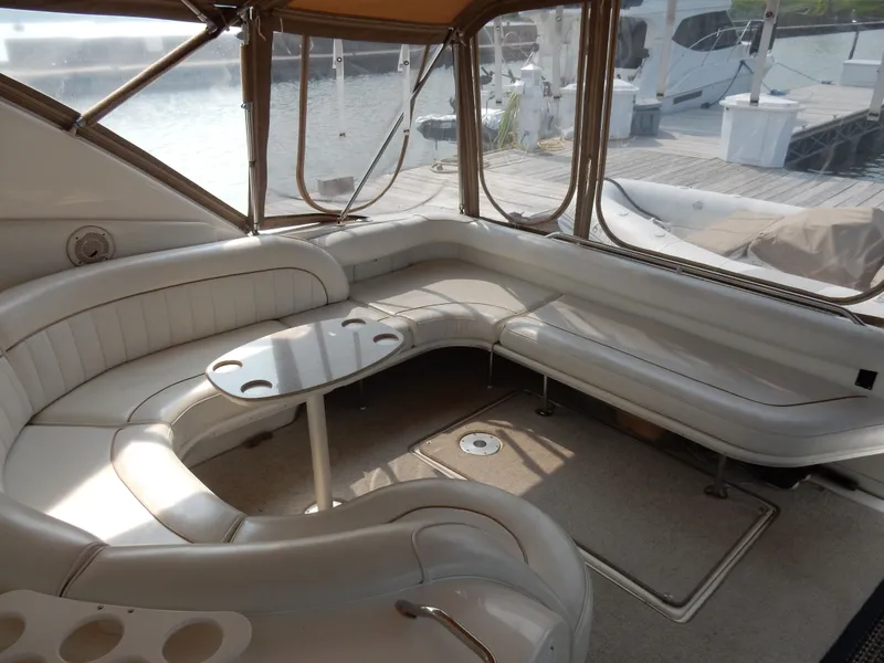 Slide: The Image of Interior of a 1997 Sea Ray 450 Sundancer yacht with seating area. - 13
