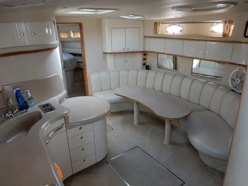 Slide: The Image of Interior of a 1997 Sea Ray 450 Sundancer yacht with elegant seating area. - 16