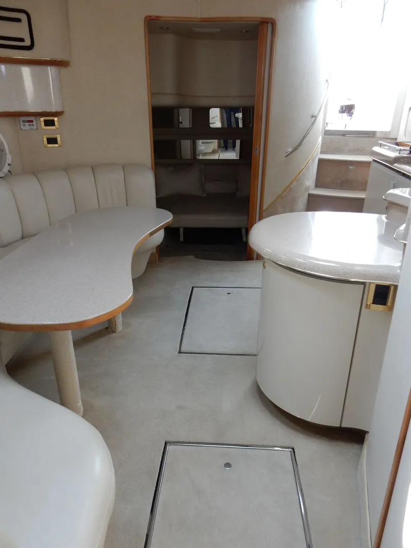 Slide: The Image of Interior of a 1997 Sea Ray 450 Sundancer yacht with elegant furnishings. - 22