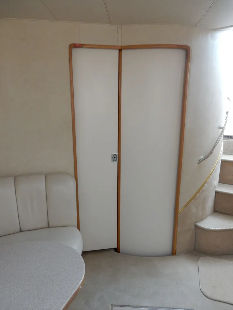 Slide: The Image of Interior of 1997 Sea Ray 450 Sundancer with stairs and seating area. - 24