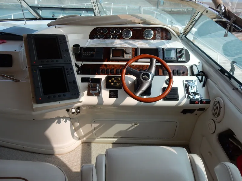 Slide: The Image of 1997 Sea Ray 450 Sundancer cockpit with wood steering wheel and instruments. - 5