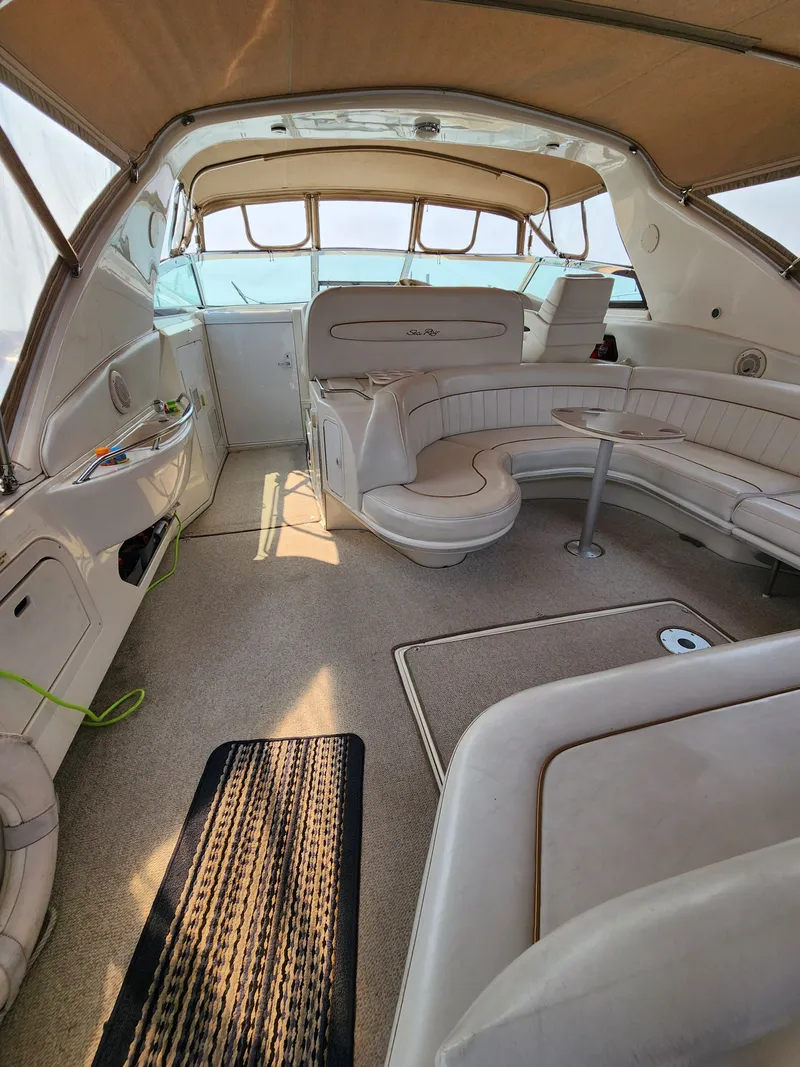 Slide: The Image of Interior of a 1997 Sea Ray 450 Sundancer yacht with beige seating. - 8