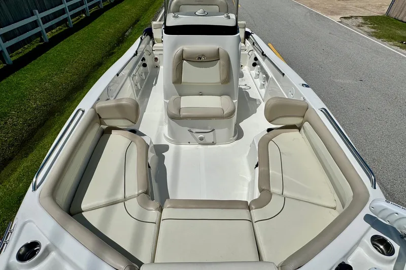 Slide: The Image of 2017 NauticStar 211 Coastal boat interior with beige seating and spacious layout. - 15