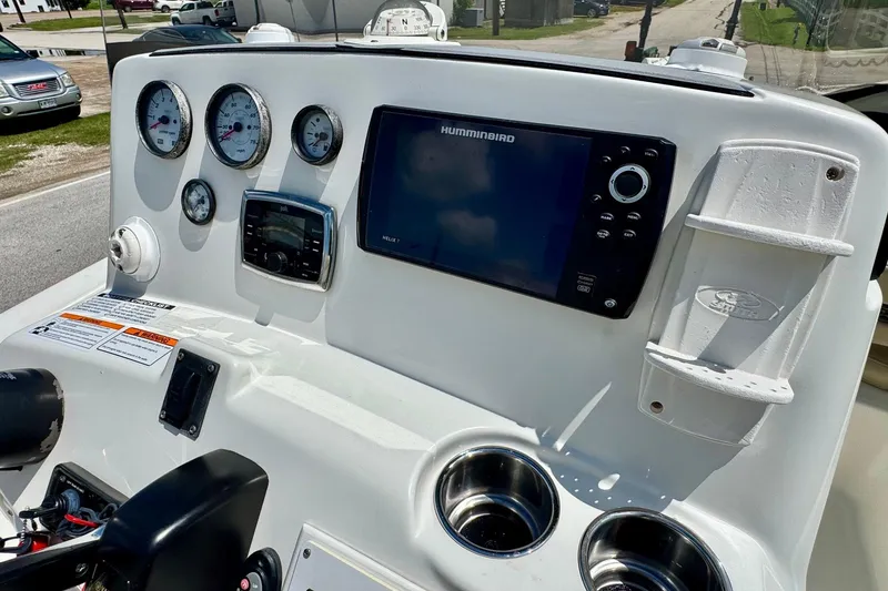 Slide: The Image of 2017 NauticStar 211 Coastal boat dashboard with gauges and Humminbird display. - 16