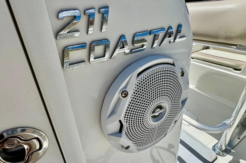 Slide: The Image of 2017 NauticStar 211 Coastal boat interior with speaker and logo detail. - 18
