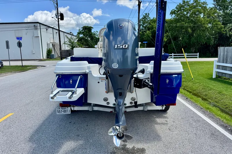 Slide: The Image of 2017 NauticStar 211 Coastal boat with Yamaha 150 outboard motor on a street. - 3