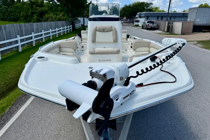 Slide: The Image of 2017 NauticStar 211 Coastal boat with Minn Kota trolling motor on a trailer. - 6