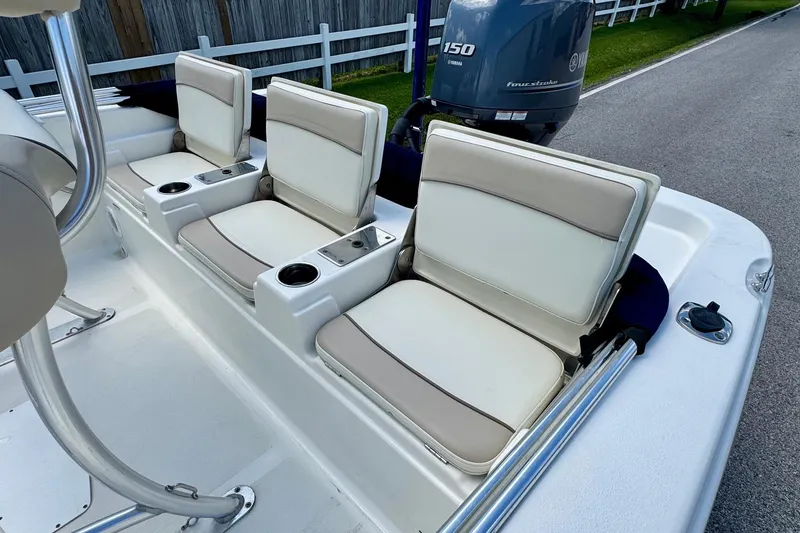 Slide: The Image of 2017 NauticStar 211 Coastal boat seats with cup holders and Yamaha 150 engine. - 7