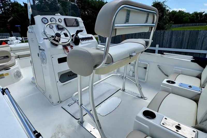 Slide: The Image of 2017 NauticStar 211 Coastal boat interior with helm, seating, and control panel. - 8