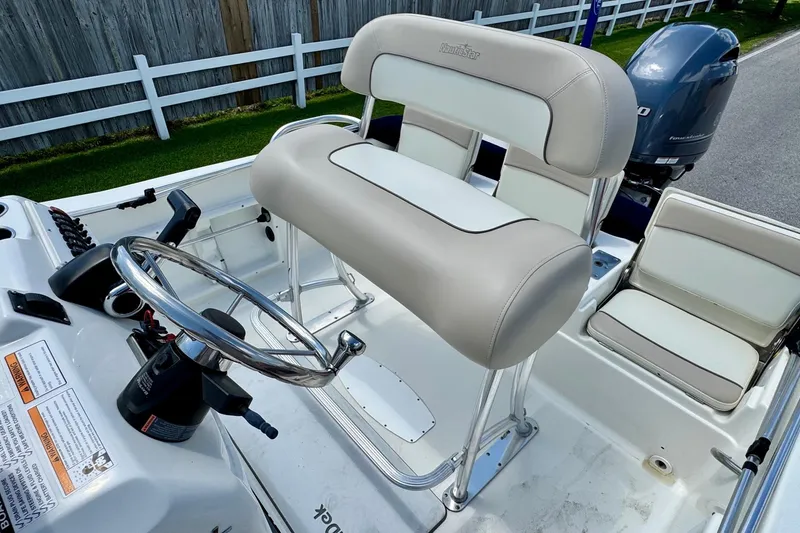 Slide: The Image of 2017 NauticStar 211 Coastal boat interior with steering wheel and seating. - 9