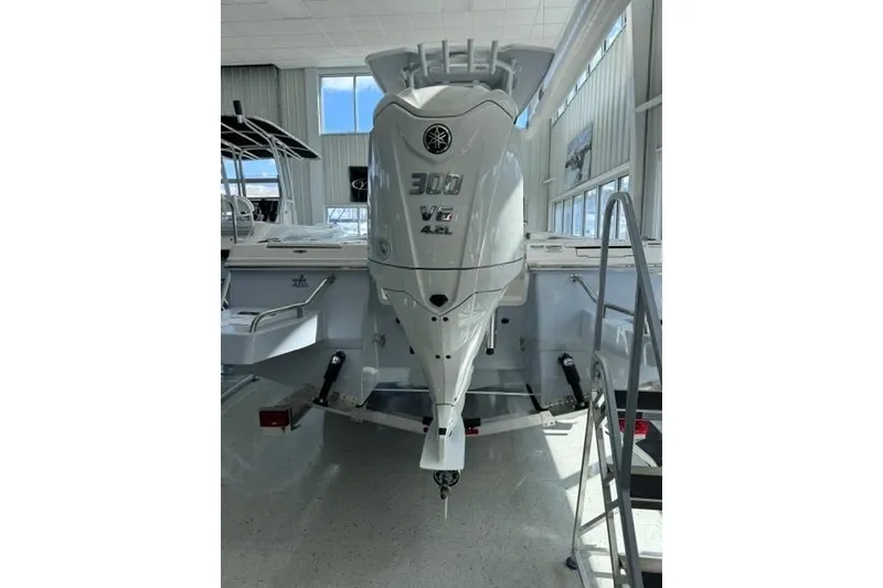 Slide: The Image of 2023 Robalo 246 Cayman with Yamaha 300 V6 4.2L outboard engine in showroom. - 2