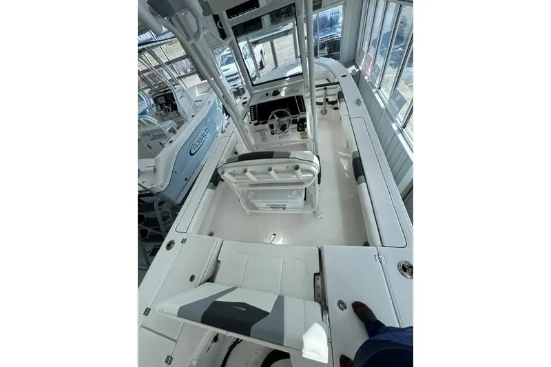 Slide: The Image of 2023 Robalo 246 Cayman boat interior with helm and seating area. - 6