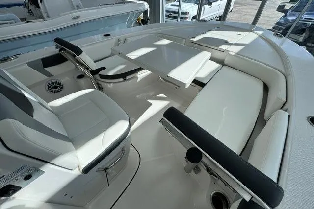 Slide: The Image of 2023 Robalo 246 Cayman boat interior with seating and table, showcasing modern design. - 8