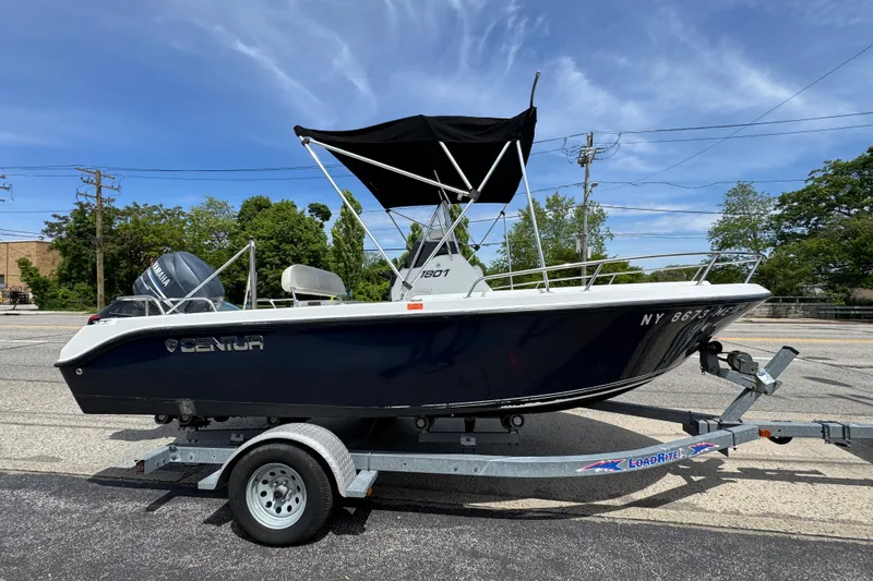 The Image of 2010 Century 1801 Center Console boat on trailer, featuring a Yamaha outboard motor. - 1