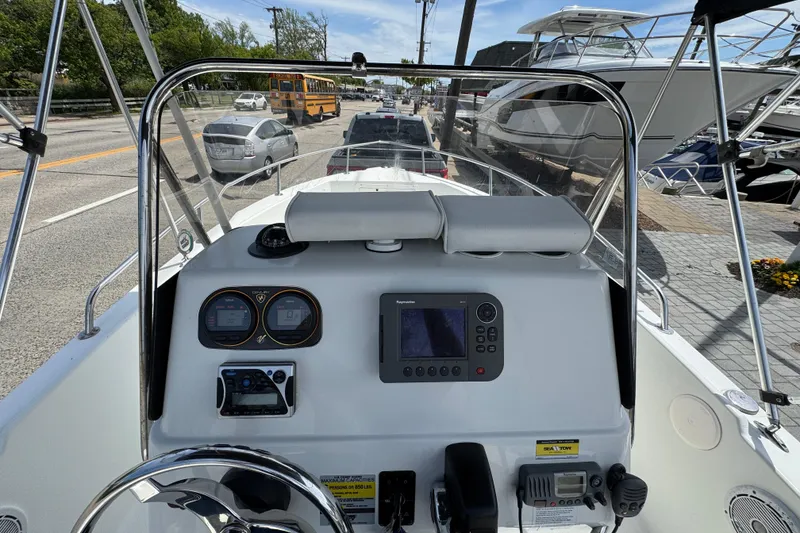 Slide: The Image of 2010 Century 1801 Center Console boat dashboard with navigation equipment and steering wheel. - 3
