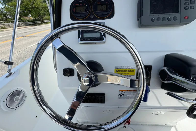 Slide: The Image of Steering wheel and controls of a 2010 Century 1801 Center Console boat. - 4