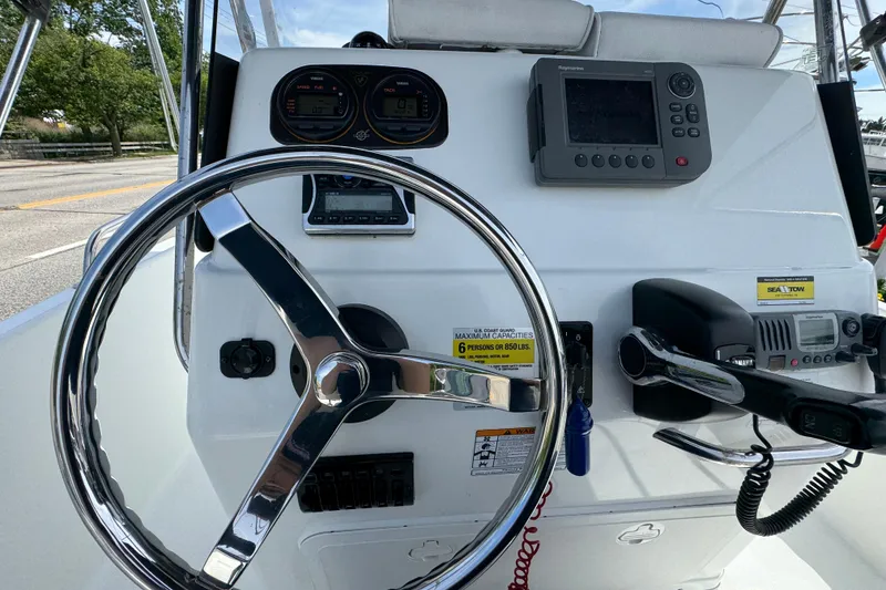 Slide: The Image of Center console of a 2010 Century 1801 boat with steering wheel and navigation equipment. - 8