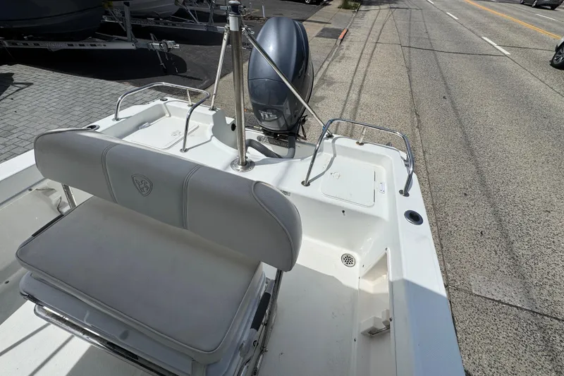 Slide: The Image of 2010 Century 1801 Center Console boat with seating and outboard motor on display. - 9
