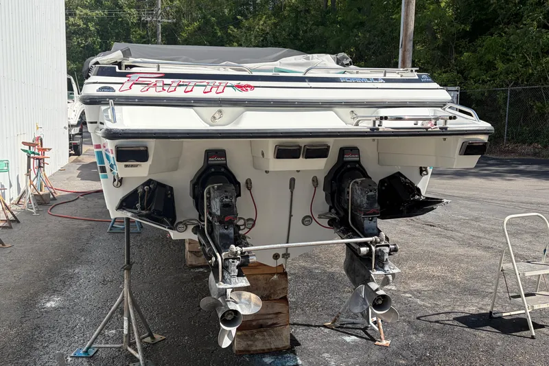 Slide: The Image of 1991 Formula 311 SR-1 boat with dual outboard motors on a maintenance stand. - 3