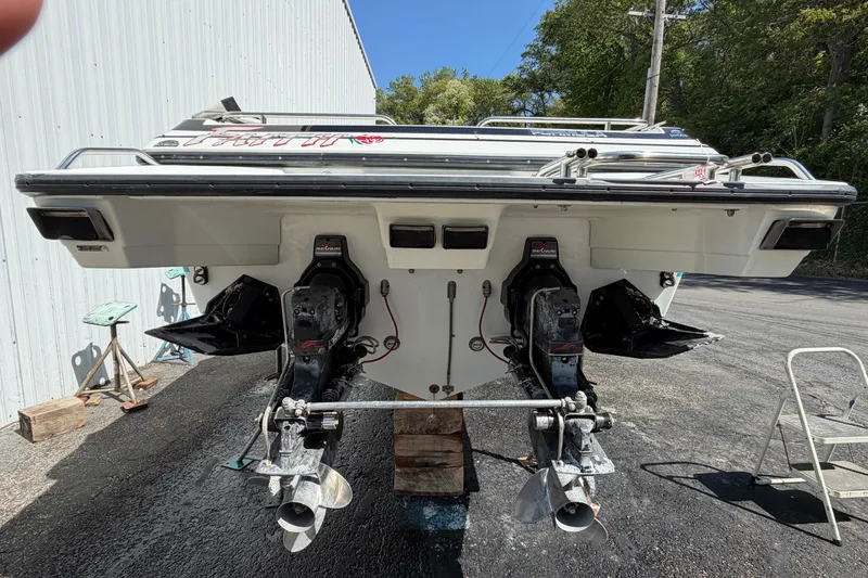 Slide: The Image of 1991 Formula 311 SR-1 boat with dual outboard motors, parked outdoors. - 7