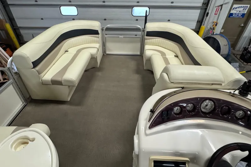 Slide: The Image of Interior of a 2008 Bennington 2075GSi pontoon boat with beige seating and dashboard. - 11