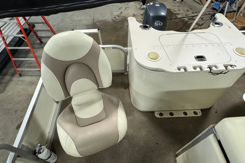 Slide: The Image of 2008 Bennington 2075GSi boat interior with beige seating and Yamaha 50 engine. - 12