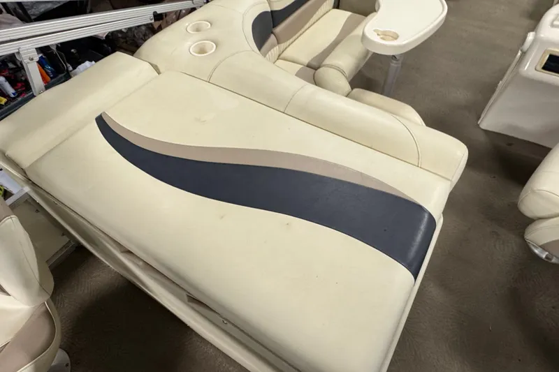 Slide: The Image of 2008 Bennington 2075GSi boat interior with beige and navy seating, cup holders, and table. - 15