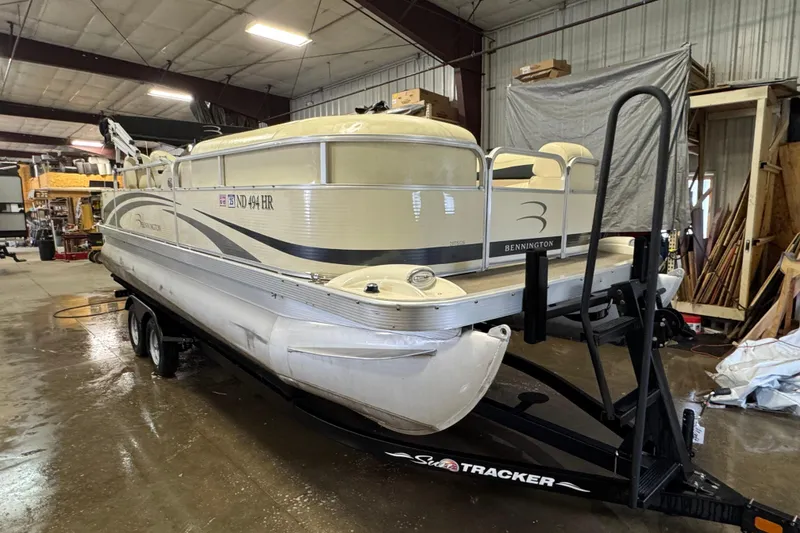 Slide: The Image of 2008 Bennington 2075GSi pontoon boat on trailer in a warehouse setting. - 2