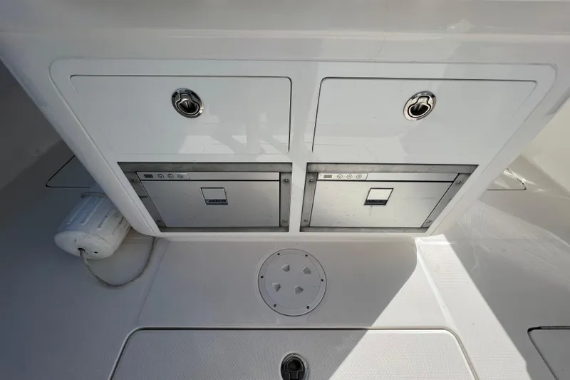 Slide: The Image of 2021 Fountain 39 NX boat storage compartments with secure latches and clean design. - 42