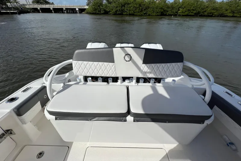 Slide: The Image of 2021 Fountain 39 NX boat seating area with quilted upholstery on a calm river. - 40
