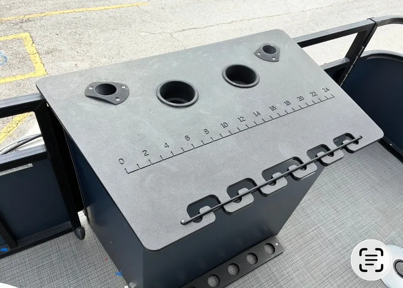 Slide: The Image of Misty Harbor DM20F 2022 boat console with cup holders and measuring scale. - 12