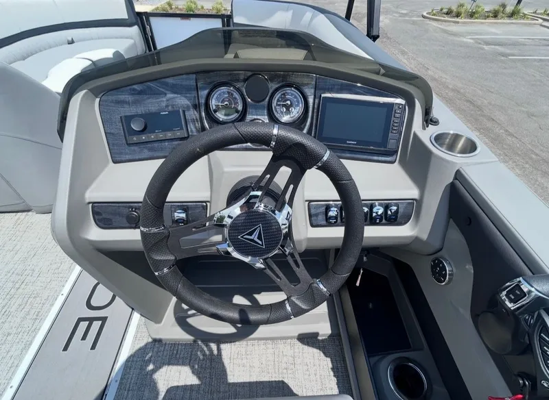 Slide: The Image of 2025 Tahoe LTZ VRB 23T DX boat console with steering wheel and instruments. - 13