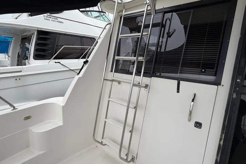 Slide: The Image of 1996 Bayliner 3988 Command Bridge Motoryacht with stainless steel ladder and sleek design. - 12