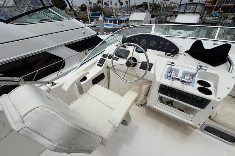 Slide: The Image of 1996 Bayliner 3988 Command Bridge Motoryacht helm with steering wheel and control panel. - 14