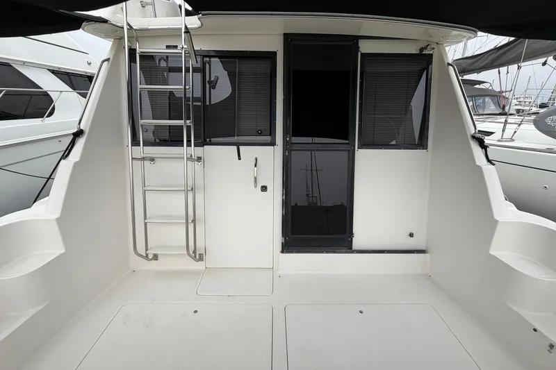 Slide: The Image of 1996 Bayliner 3988 Command Bridge Motoryacht cockpit with ladder and sliding doors. - 17