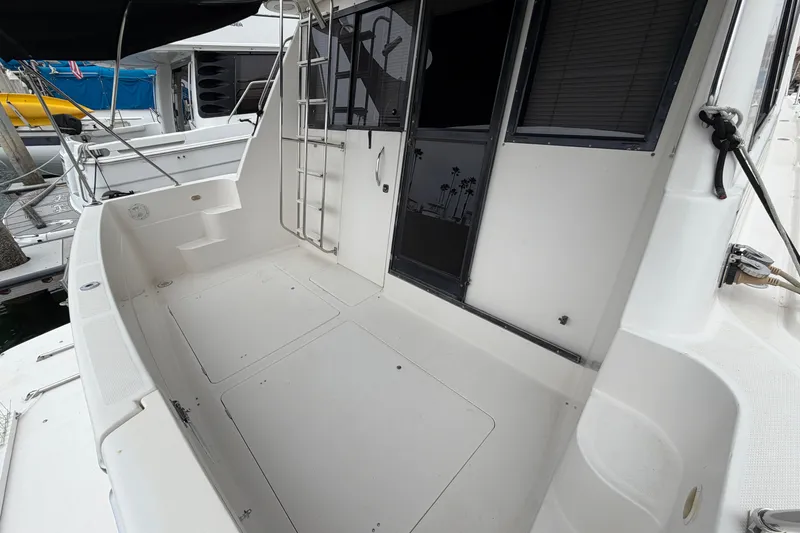 Slide: The Image of 1996 Bayliner 3988 Command Bridge Motoryacht deck with ladder and seating area. - 18