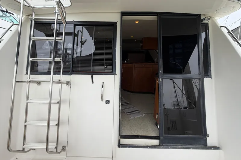 Slide: The Image of 1996 Bayliner 3988 Command Bridge Motoryacht entrance with ladder and sliding door. - 22