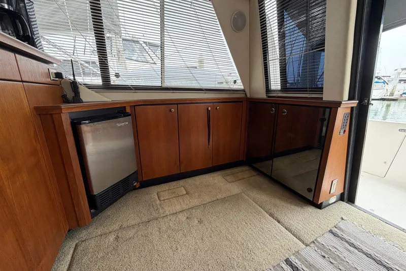 Slide: The Image of Interior of 1996 Bayliner 3988 Command Bridge Motoryacht with wood cabinets and mini fridge. - 26