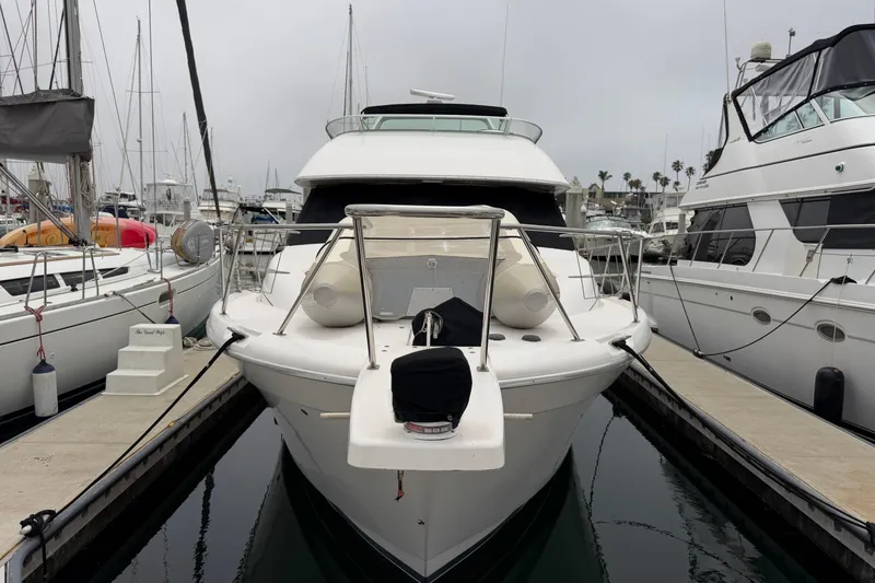 Slide: The Image of 1996 Bayliner 3988 Command Bridge Motoryacht docked at marina, surrounded by other boats. - 3